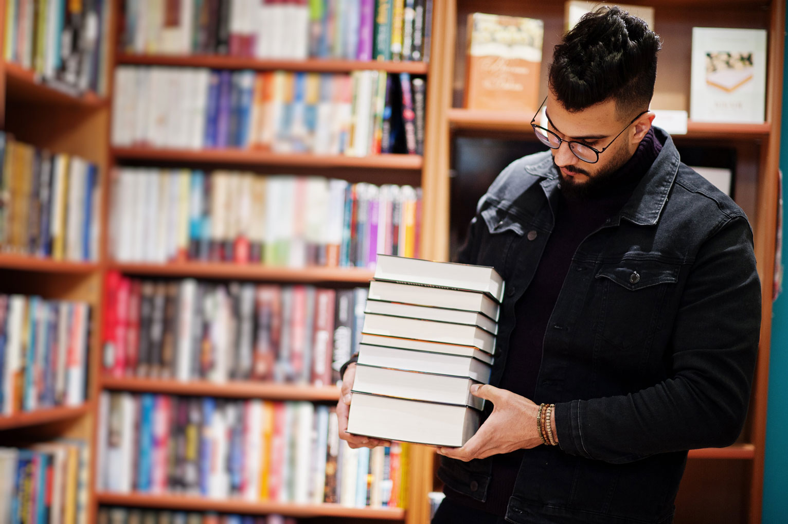 tall-smart-arab-student-man-wear-black-jeans-jacket-eyeglasses-library-with-stack-books-min.jpg